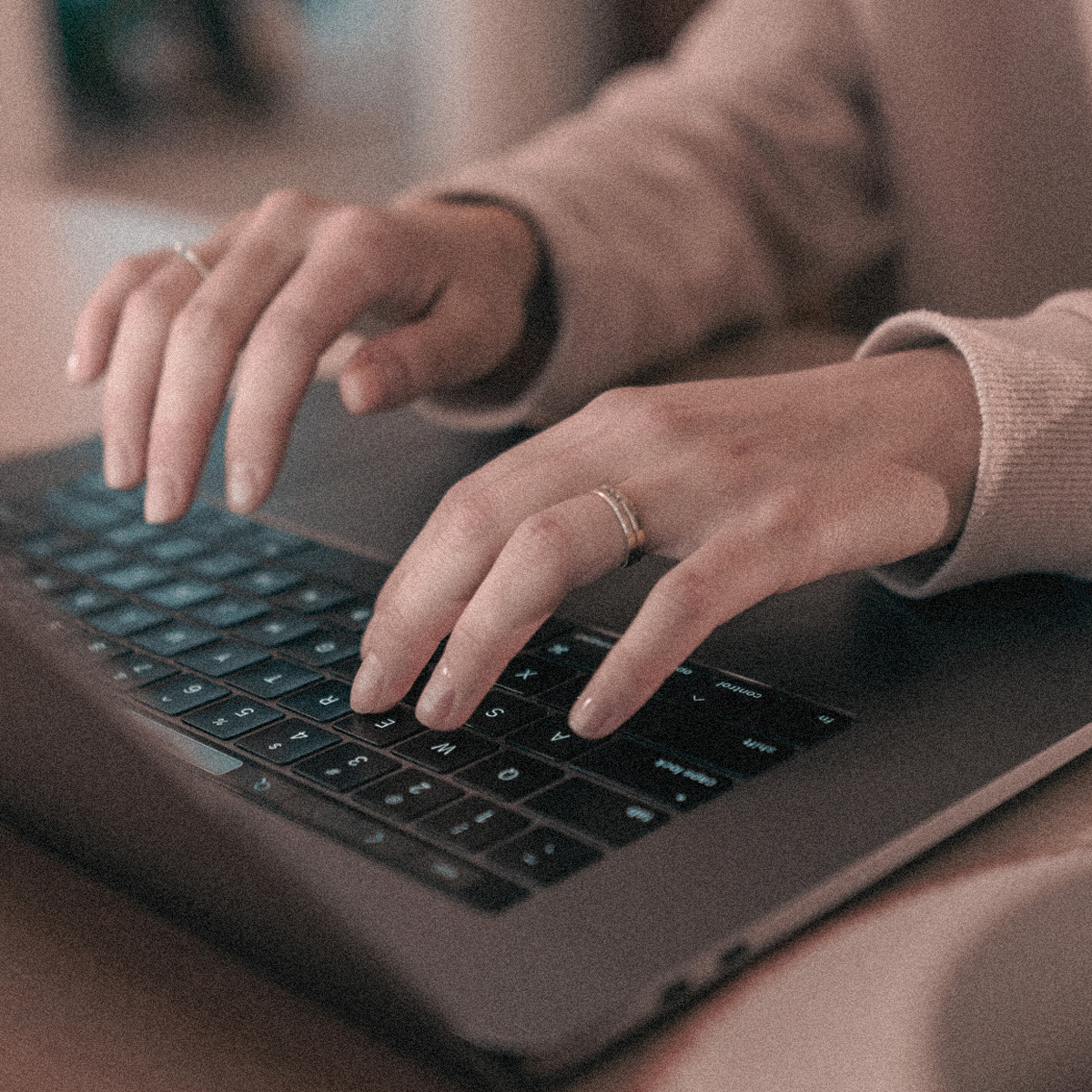 Hands typing on a laptop keyboard, representing Creative Hospitality’s software solutions that streamline operations and improve team performance.